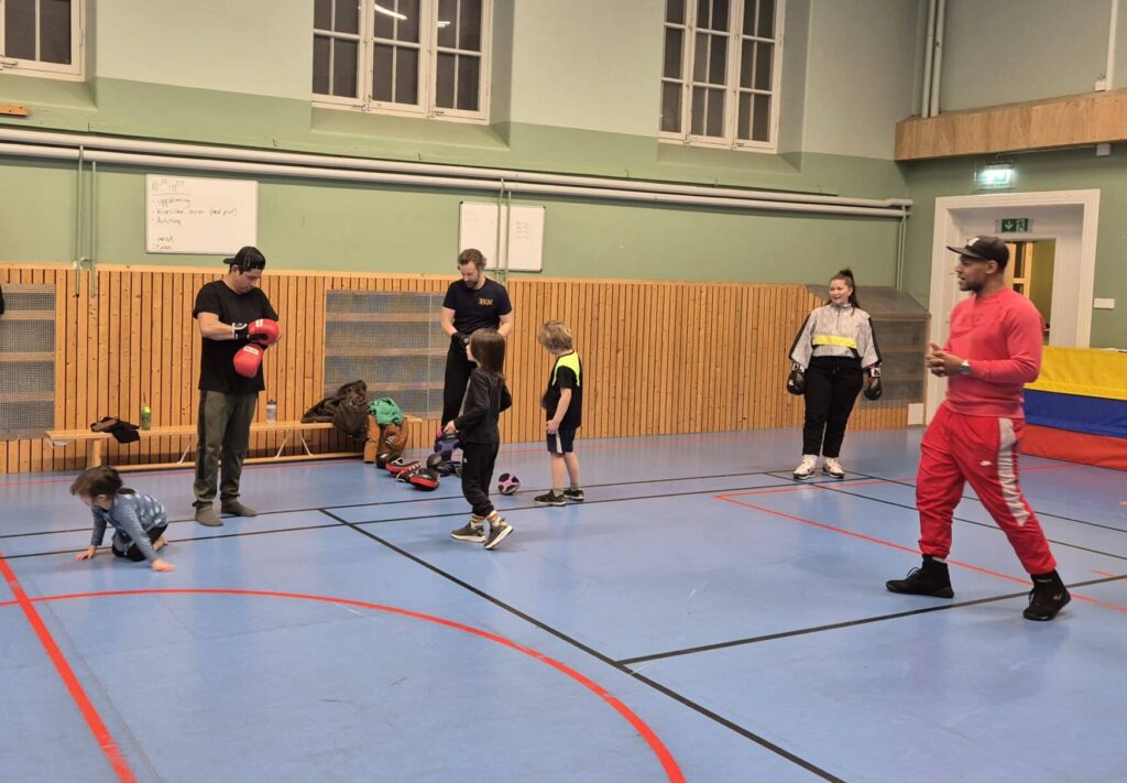 Parents training boxing with their children